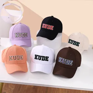 Detail showing embroidered KUDE logo on baseball caps and internal mesh structure