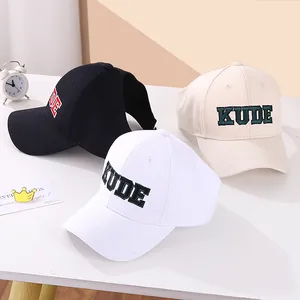 Adjustable ponytail baseball cap with KUDE embroidery in black, white, and beige