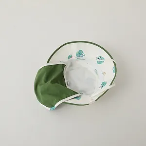 Detail of toddler sun hat with green trim and neck protection fabric with cute prints