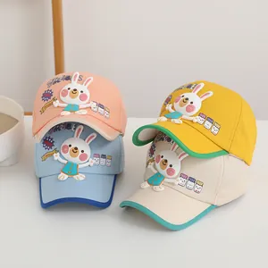 Détail des écussons lapin et des broderies colorées sur casquettes en coton pour enfants