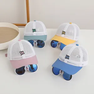 Detail of colorful breathable mesh baseball caps for kids with M letter embroidery