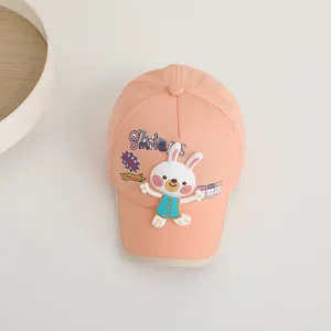 Détail de la casquette rose pêche avec écusson lapin 3D et imprimé texte Smile
