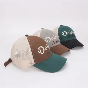 Detail of mesh trucker hats with Dolphin Archive embroidery in various color schemes
