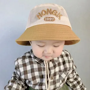 Detail of breathable mesh kids bucket hat with HONGK 1997 embroidery and drawstring