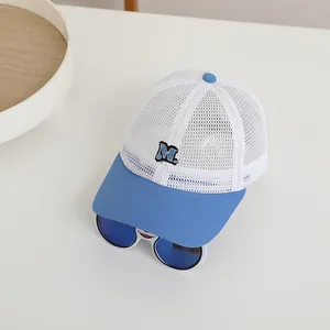 Close-up of blue and white breathable mesh baseball cap with embroidered M and sunglasses