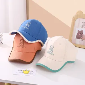 Childrens embroidered bear baseball caps with contrast brim in blue pink and beige