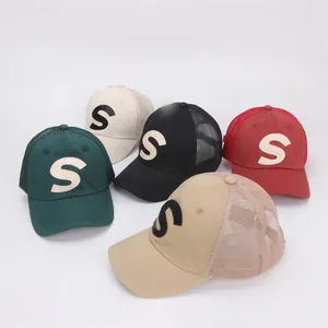 Detailed view of breathable mesh back and 3D embroidered S letter on five color trucker hats