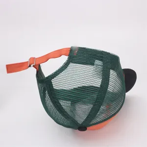 Detail view of adjustable strap with metal buckle on mesh trucker hat back