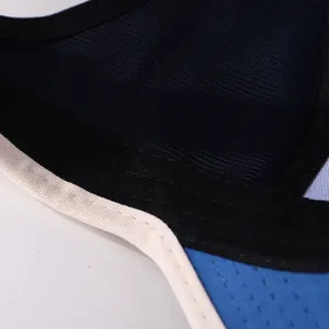 Close-up of breathable blue mesh fabric with fine stitching on a kids baseball cap