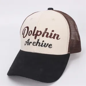 Detail of tricolor kids trucker hat featuring Dolphin Archive embroidery and mesh panels