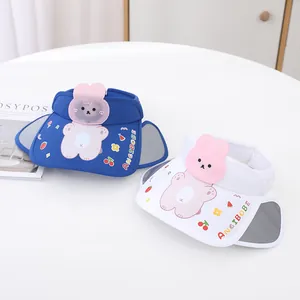 Detail of blue and white cartoon rabbit sun visors with fruit patterns for children
