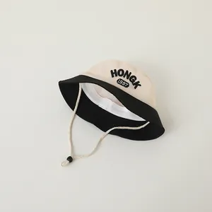 Detail of HONGK 1997 embroidery on a two-tone breathable sun hat with adjustable cord