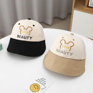 Detail view of two breathable mesh bucket hats for kids in beige with soft brims