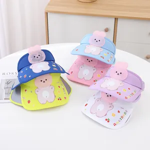 Detail view of colorful kids sun visors featuring cartoon bear motifs and elastic bands