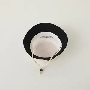 Macro view of breathable mesh lining and adjustable chin strap on the sun hat