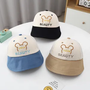 Close-up of three mesh breathable sun hats for kids in black, blue, and khaki colors