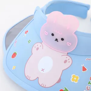 Detail of baby sun visor featuring a 3D pink rabbit and colorful cartoon patterns