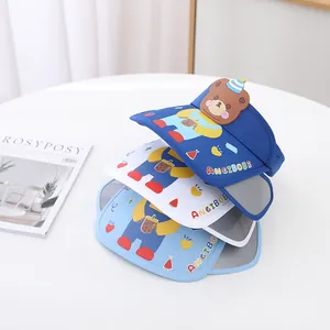 Detail view of the colorful cartoon bear silicone ornaments on sun visor hats for kids