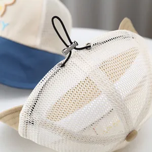Detail of adjustable elastic drawstring and silver toggle on kids breathable mesh sun hat