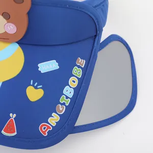 Detail of navy sun visor with cartoon bear patches and retractable side eye shields