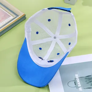 Detail view of the breathable white mesh and adjustable velcro strap on a blue trucker hat
