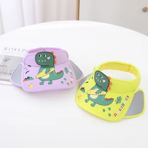 Detail view of purple and yellow kids sun visors with cute green dinosaur design