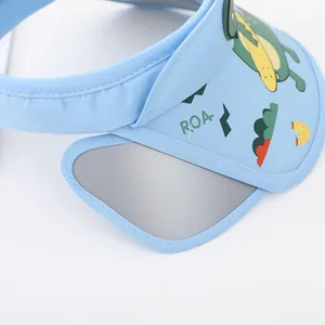 Detailed view of light blue kids sun visor with cute dinosaur print and wide side wings