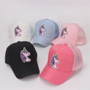 Detail of five kids mesh trucker hats with sparkly sequin unicorn patches in multiple colors