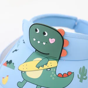 Detail of blue kids sun hat featuring a 3D cartoon dinosaur playing skateboard