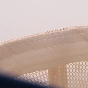 Macro detail of breathable mesh fabric and reinforced sweatband on kids baseball cap