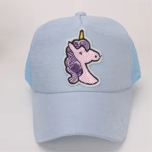 Detail of children's baseball cap featuring a shiny unicorn sequin patch and mesh back