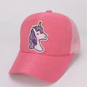 Detailed close-up of a pink trucker hat featuring a sequined cartoon unicorn embroidery