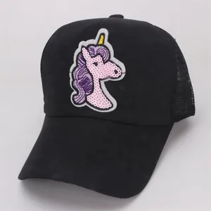 Close-up of black mesh back and shiny sequin unicorn embroidery on the girl's baseball cap