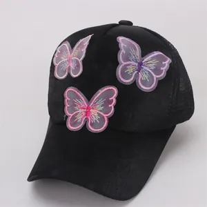 Close-up of butterfly embroidery on black mesh breathable baseball cap for kids