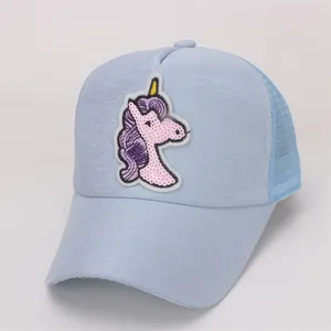 Detail of sequin unicorn patch on light blue mesh baseball cap for girls