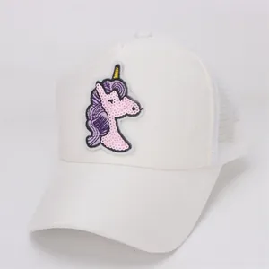 Detailed view of kids white trucker hat with sparkling sequin unicorn patch and mesh