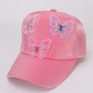 Detail of pink velvet baseball cap featuring delicate 3D mesh butterfly embroidery
