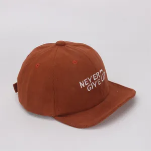 Detalle de gorra de béisbol de pana marrón con bordado Never Give Up para niños y bebés