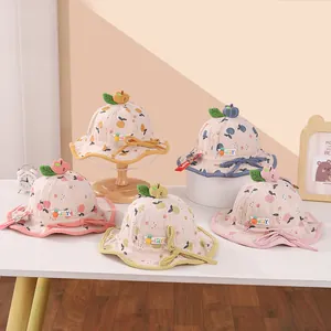 Detail of corduroy baby fisherman hats with 3D fruit designs and scalloped wavy brims