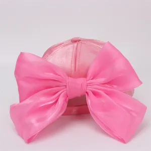 Pink girls baseball cap with a large decorative satin bow on the back and minimalist style