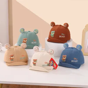 Detail view of colorful corduroy baby baseball caps with 3D bear ears and cute embroidery