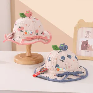 Plush corduroy baby bucket hats in pink and blue with cherry prints and ear accents