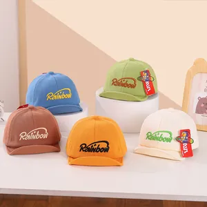 Close-up of baby baseball caps with Rainbow embroidery in five soft knit colors