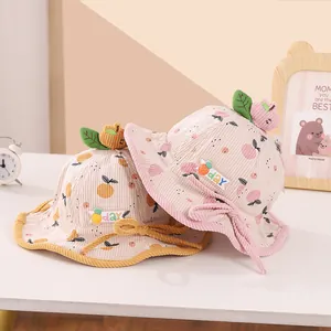 Close-up of children corduroy bucket hat with fruit decor and adjustable chin strap