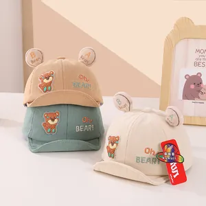 Three corduroy baby baseball caps with bear ears in yellow, green and cream colors