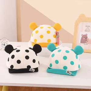 Detailed view of baby baseball hats with polka dots and cute bear ears in three colors