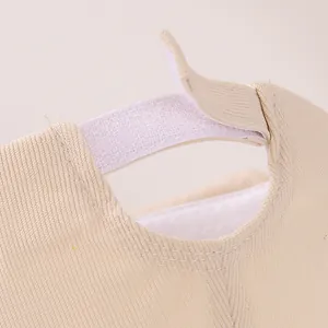Detail of adjustable hook-and-loop closure on beige cotton baby baseball cap