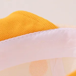 Detail of yellow knit fabric texture and white satin sweatband with reinforced stitching