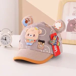 Detail of khaki corduroy baby baseball cap featuring 3D bear ears and a silicone bear icon