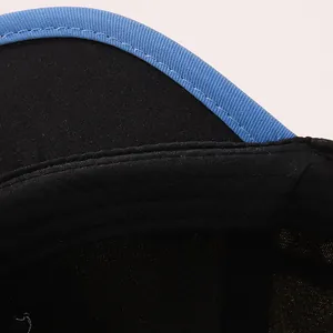 Detail of multi-row stitching on black toddler baseball cap with blue trim and twill fabric